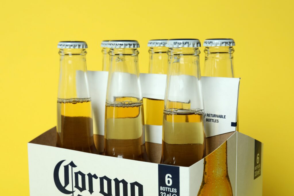 Carton Box with Corona Extra on Yellow Background - Corona Extra beer distributor