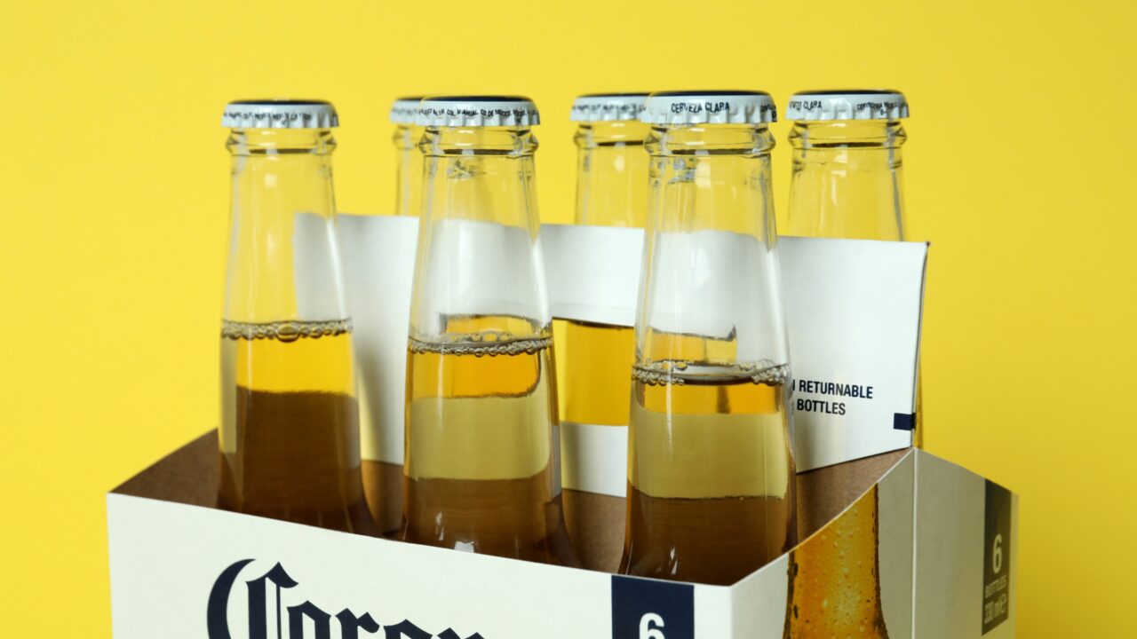Carton Box with Corona Extra on Yellow Background - Corona Extra beer distributor